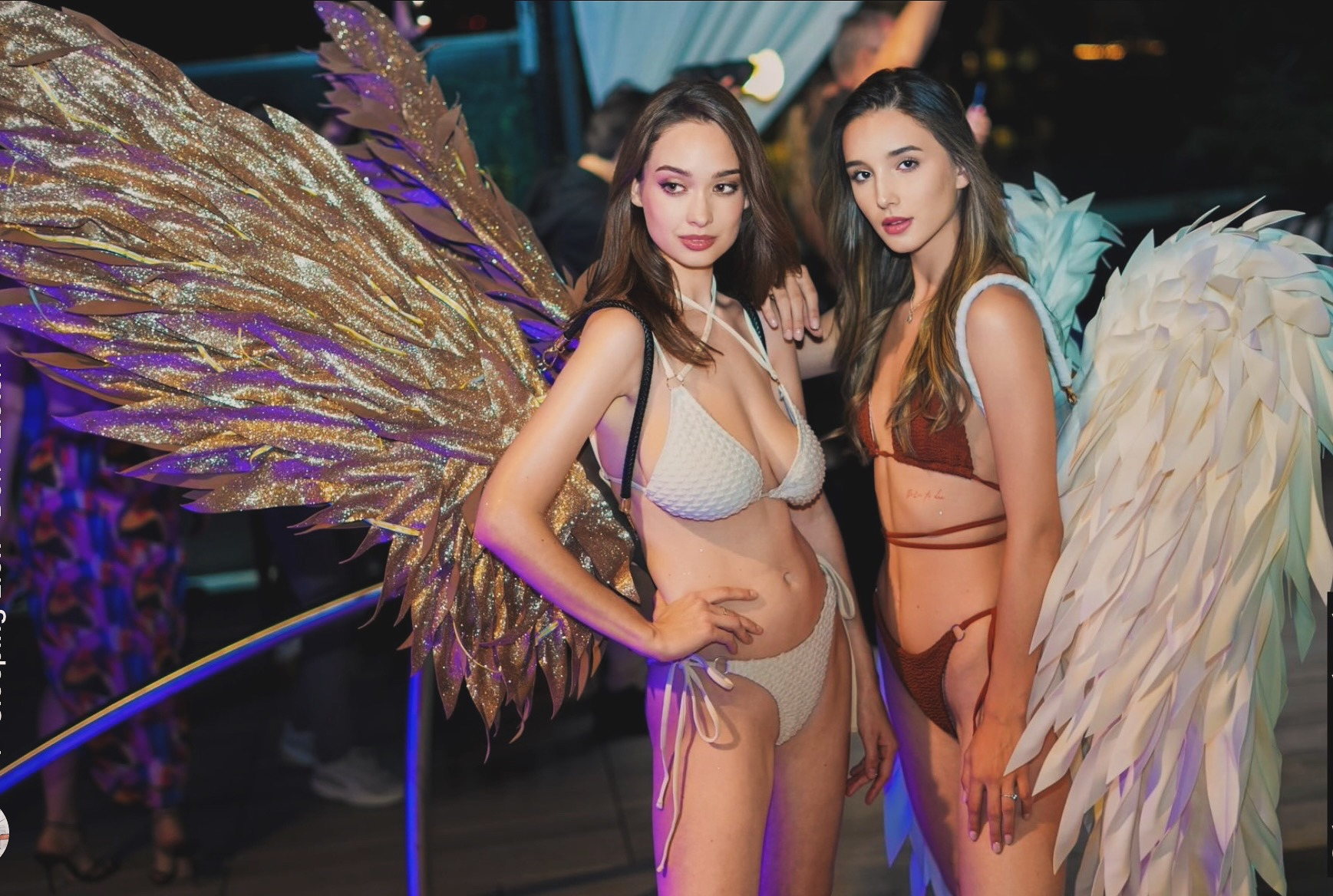 Toronto Swim Week models in swimwear with sculptural angel wings at an event
